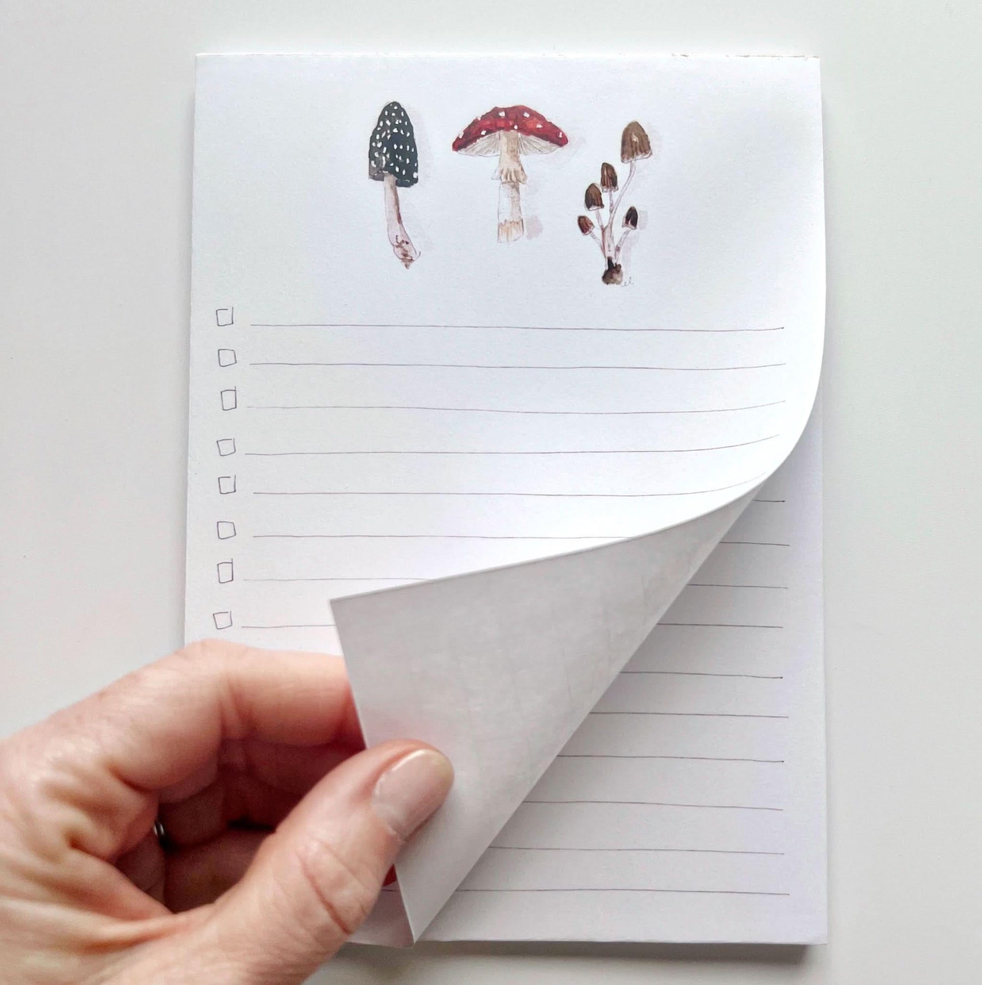 mushroom checklist notepad with hand